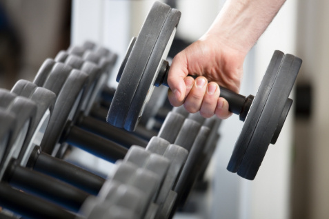 hand holding dumbell in gym