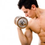 shirtless man working out with dumbell